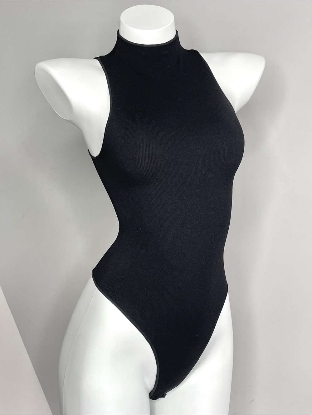 Naked Wardrobe Black Ribbed Sleeveless Mock Neck Bodysuit